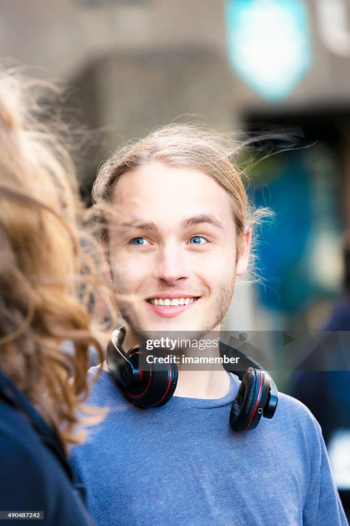 Portrait of nineteen years old young man talking and smiling