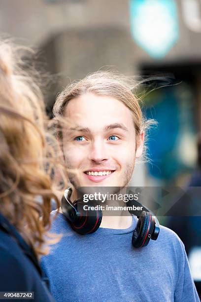 portrait of nineteen years old young man talking and smiling - 18 19 years stock pictures, royalty-free photos & images