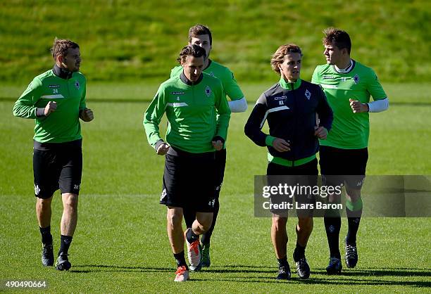 Tony Jantschke, Roel Brouwers and Granit Xhaka warm up during a Borussia Moenchengladbach training session on the eve of the UEFA Champions League...