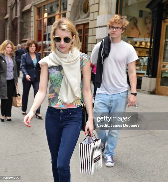 Emma Roberts and Evan Peters leave Henri Bendel on May 14, 2014 in New York City.