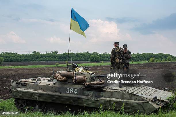 Ukrainian soldiers guard a checkpoint on May 14, 2014 in Novatroizk, Ukraine. Pro-Russian militants ambushed Ukrainian troops nearby the day before,...