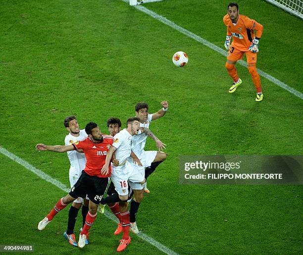 Benfica's Argentinian defender Ezequiel Garay fights for the ball with Sevilla's defender Alberto Moreno as Sevilla's Portuguese goalkeeper Beto...