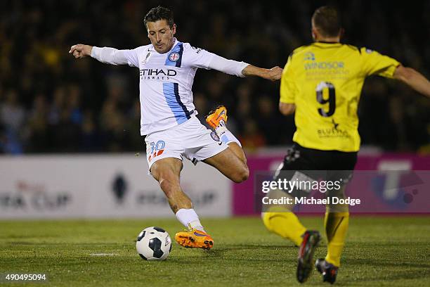 Robert Koren of the City akicks the ball past Kostas Kanakaris of United during the FFA Cup Quarter Final match between Heidleberg United and...