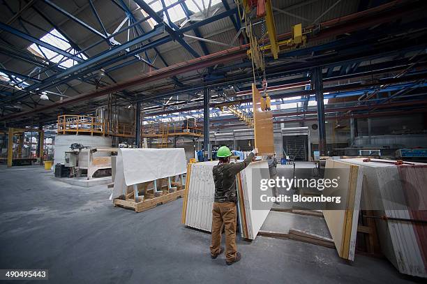 Employees load finished sheets for countertops to be shipped at the IceStone LLC manufacturing facility in the Brooklyn borough of New York, U.S., on...