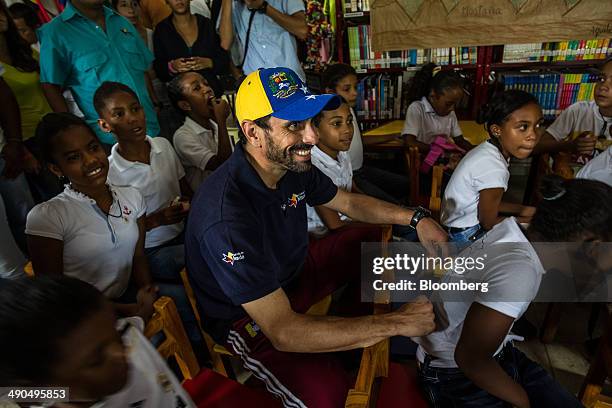 Henrique Capriles, governor of the state of Miranda and a former presidential candidate in the last two elections, center, watches a performance by...