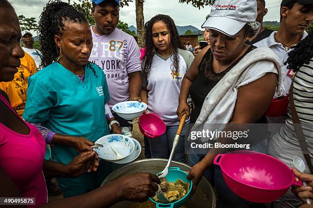 Residents wait to be served a free lunch sponsored by Henrique Capriles, governor of the state of Miranda and a former presidential candidate in the...