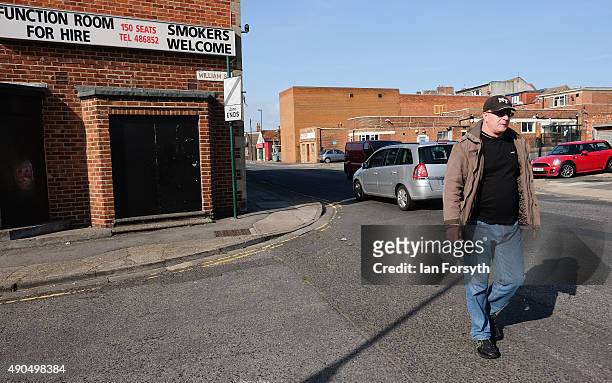 Man walks through Redcar past a club advertising a function room on September 29, 2015 in Redcar, England. Following the announcement by SSI UK that...