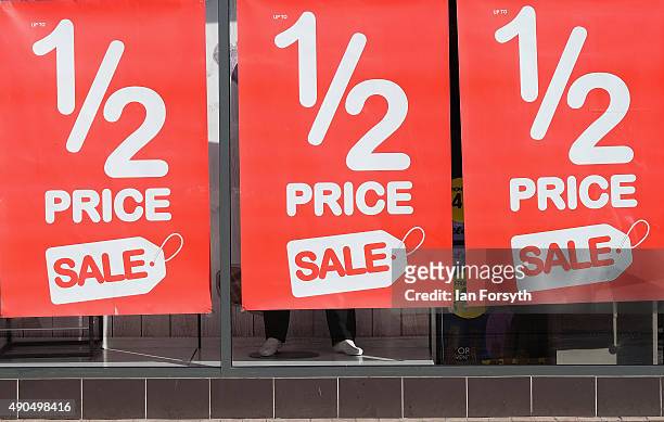 Posters advertising a sale are displayed in a shop window of a shop in the high street on September 29, 2015 in Redcar, England. Following the...