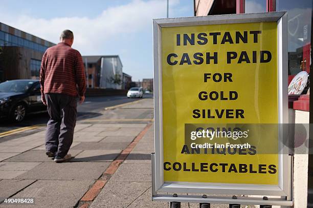 Man walks past an advertisement for instant cash on September 29, 2015 in Redcar, England. Following the announcement by SSI UK that the steel...