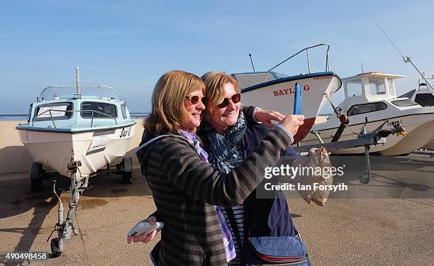 Two women on Redcar seafront take a selfie in front of fishing boats on September 29, 2015 in Redcar, England. Following the announcement by SSI UK...