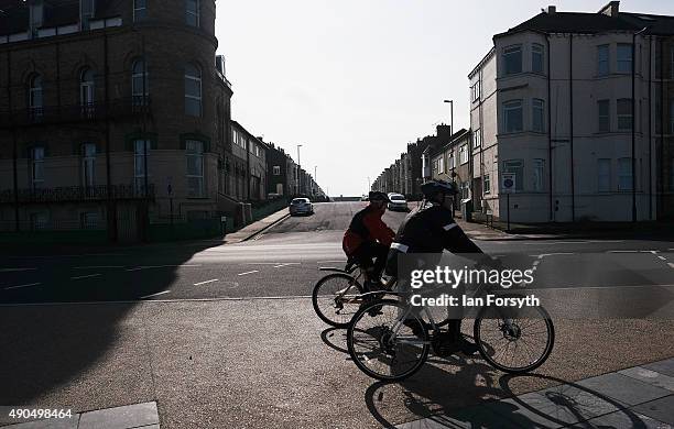 Two men on bicycles ride along the main road on the seafront on September 29, 2015 in Redcar, England. Following the announcement by SSI UK that the...