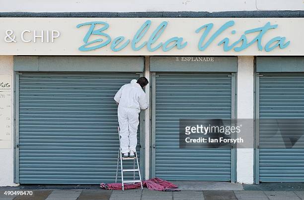 Man paints the shop front of a property on September 29, 2015 in Redcar, England. Following the announcement by SSI UK that the steel manufacturing...