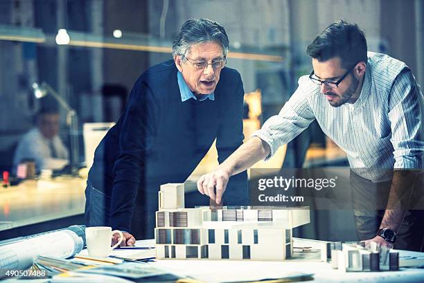 two architects discussing new project - model building stockfoto's en -beelden