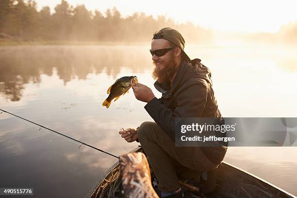 carpe diem…seize the fish - young men fishing stock pictures, royalty-free photos & images