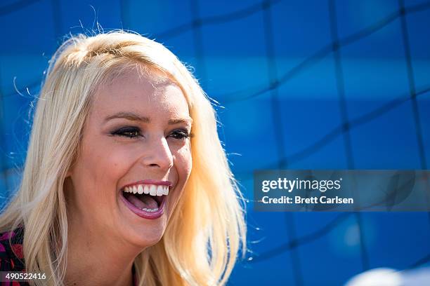 Reporter Britt McHenry laughs with colleagues on the sidelines before the game between the Buffalo Bills and the New England Patriots on September...