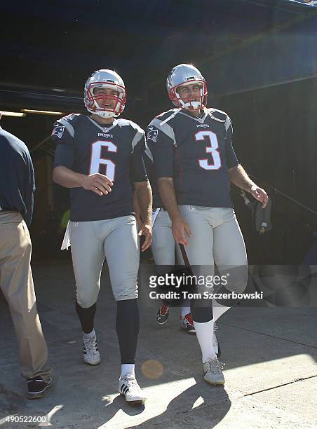 Ryan Allen of the New England Patriots and Stephen Gostkowski walk on the field from the runway before the start of NFL game action against the...