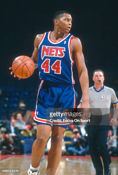 Derrick Coleman of the New Jersey Nets dribbles the ball against the Philadelphia 76ers during an NBA basketball game circa 1992 at The Spectrum in...