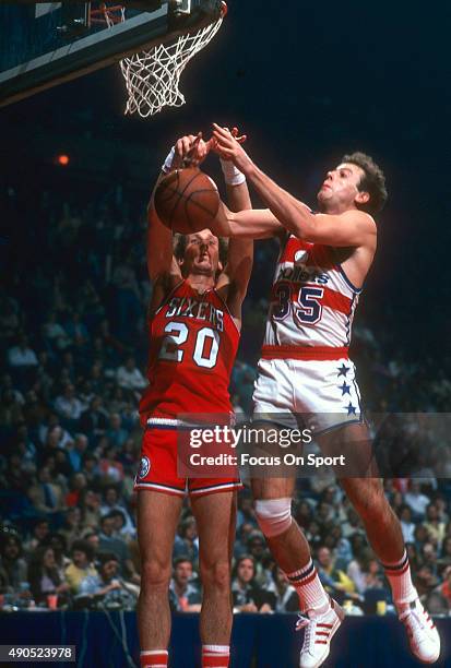 Doug Collins of the Philadelphia 76ers fights for a rebound with Kevin Grevey of the Washington Bullets during an NBA basketball game circa 1978 at...