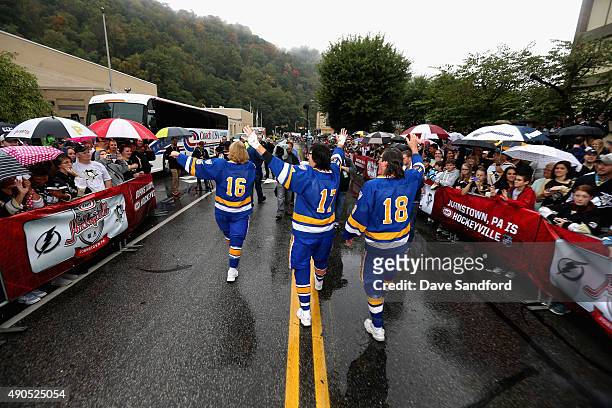 The Hanson Brothers, Dave Hanson, Steve Carlson and Jeff Carlson walk down the street greeting fans outside the Cambria County War Memorial Arena...