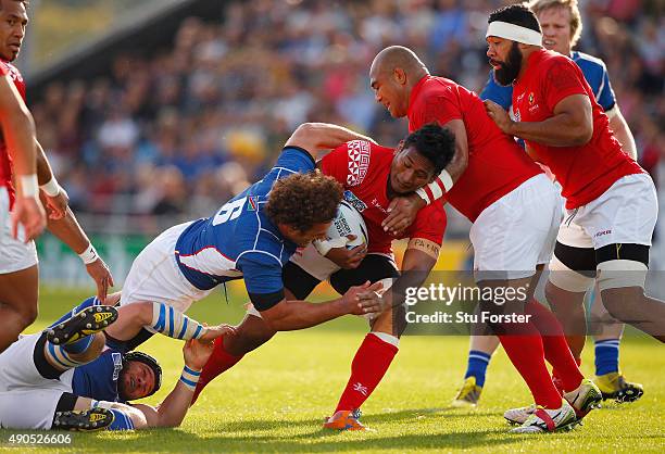 Jack Ram of Tonga is tackled by Jacques Burger of Namibia during the 2015 Rugby World Cup Pool C match between Tonga and Namibia at Sandy Park on...