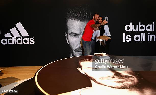 Global icon and footballing legend David Beckham pooses for a picture with a fan as he opened the new adidas HomeCourt concept store in the Mall of...