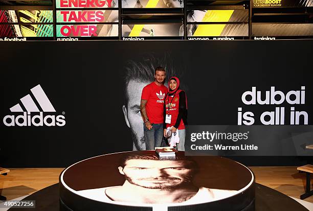 Global icon and footballing legend David Beckham poses for a picture with a fan as he opened the new adidas HomeCourt concept store in the Mall of...