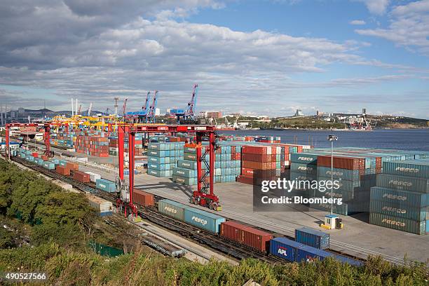 Shipping containers branded with the logo of Fesco Transportation Group sit on the dockside at the Commercial Port of Vladivostok in Vladivostok,...