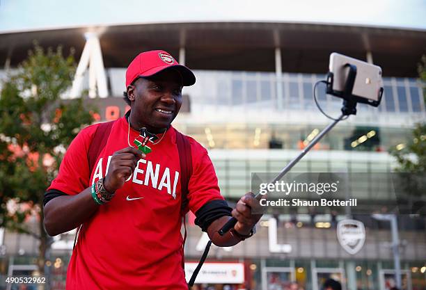 Kenyan Arsenal fan records his visit to the UEFA Champions League Group F match between Arsenal FC and Olympiacos FC at the Emirates Stadium on...