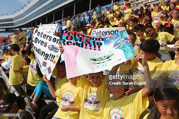 Peterson Elementary students cheer during the Speeding To Read Kickoff Assembly at Texas Motor Speedway on September 29, 2015 in Fort Worth City.