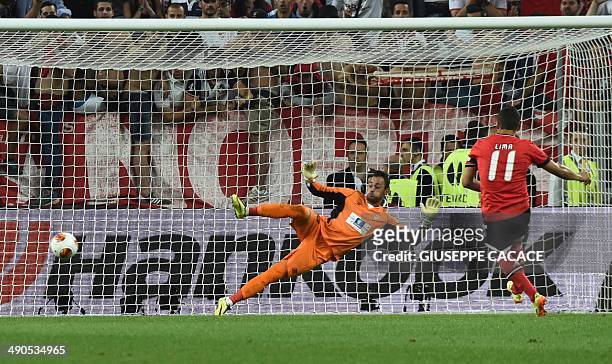 Benfica's Brazilian forward Rodrigo Lima scores past Sevilla's Portuguese goalkeeper Beto during the penalty shoot out during the UEFA Europa league...