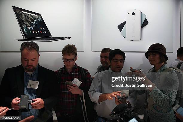 Attendees inspect the new Nexus 5X phone during a Google media event on September 29, 2015 in San Francisco, California. Google unveiled its 2015...