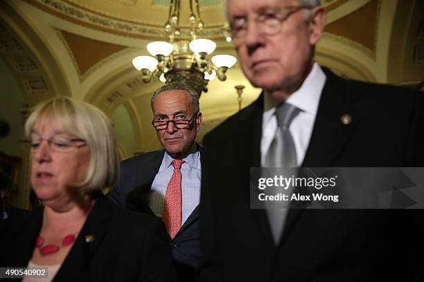 Sen. Patty Murray speaks as Sen. Charles Schumer and Senate Minority Leader Sen. Harry Reid listen during a media briefing after the weekly Senate...