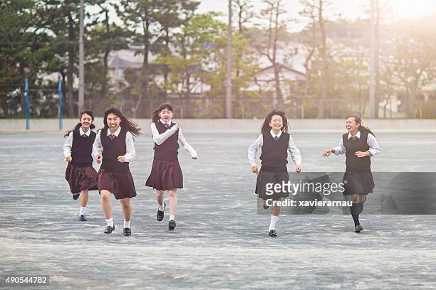 japanese students girls running in the school playground - japan 12 years girl stock pictures, royalty-free photos & images