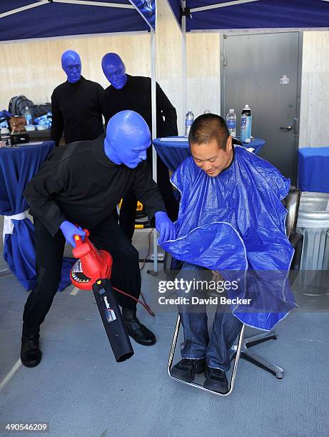 Zappos.com CEO Tony Hsieh is cleaned by a member of Blue Man Group using a garden blower before the unveiling of the "ShoeZaphone" during the annual...