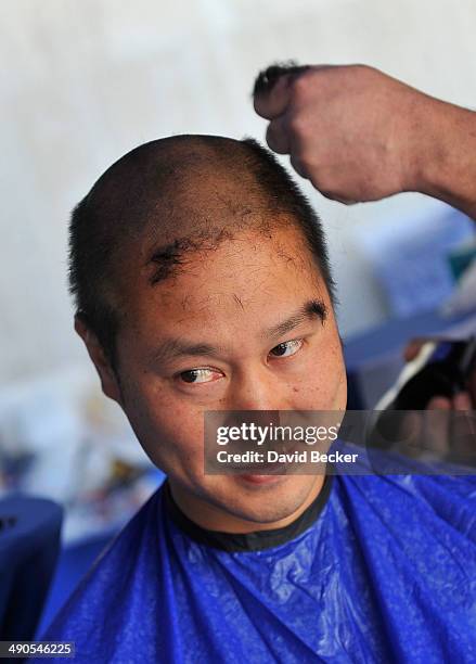 Zappos.com CEO Tony Hsieh has his head shaved before the unveiling of the "ShoeZaphone" during the annual Bald and Blue fundraiser at Zappos...