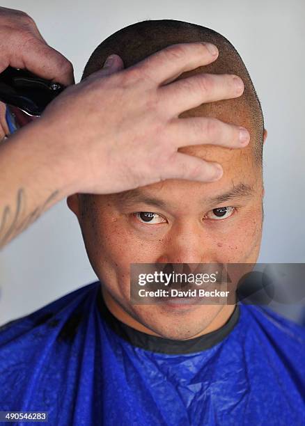 Zappos.com CEO Tony Hsieh has his head shaved before the unveiling of the "ShoeZaphone" during the annual Bald and Blue fundraiser at Zappos...