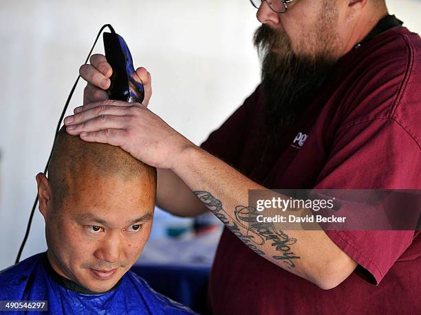 Zappos.com CEO Tony Hsieh has his head shaved before the unveiling of the "ShoeZaphone" during the annual Bald and Blue fundraiser at Zappos...