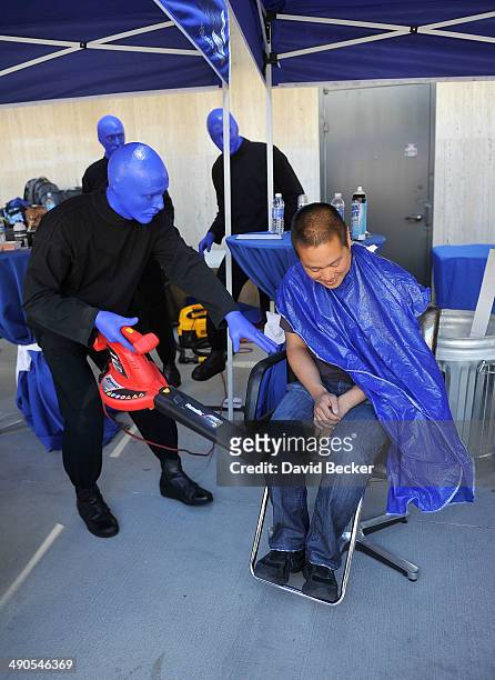 Zappos.com CEO Tony Hsieh is cleaned by a member of Blue Man Group using a garden blower before the unveiling of the "ShoeZaphone" during the annual...