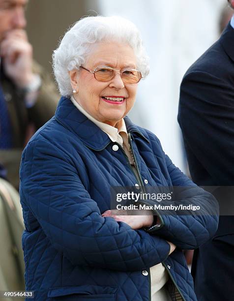 Queen Elizabeth II watches her horse 'Tower Bridge' compete in the Cuddy Four Year Old Hunter class on day 1 of the Royal Windsor Horse Show at Home...