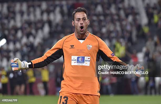 Sevilla's Portuguese goalkeeper Beto celebrates after Benfica's Spanish forward Rodrigo Machado misses a penalty during the penalty shoot out during...