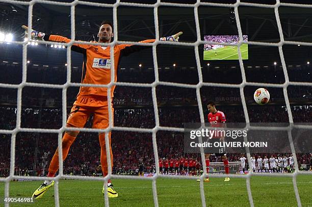 Sevilla's Portuguese goalkeeper Beto celebrates after saving a penalty by Benfica's Spanish forward Rodrigo Machado during the UEFA Europa league...