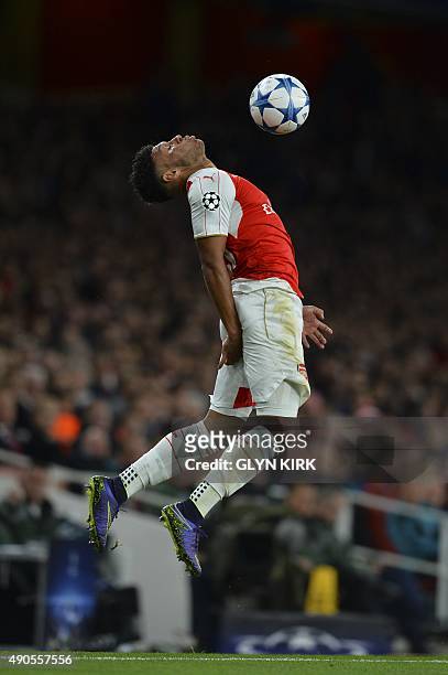 Arsenal's English midfielder Alex Oxlade-Chamberlain tries to control the ball and keep it in play as it goes out for a throw in during the UEFA...