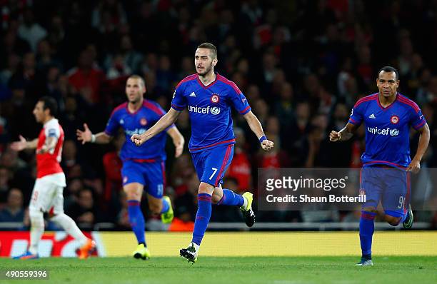 Kostas Fortounis of Olympiacos celebrates the own goal scored by David Ospina of Arsenal during the UEFA Champions League Group F match between...