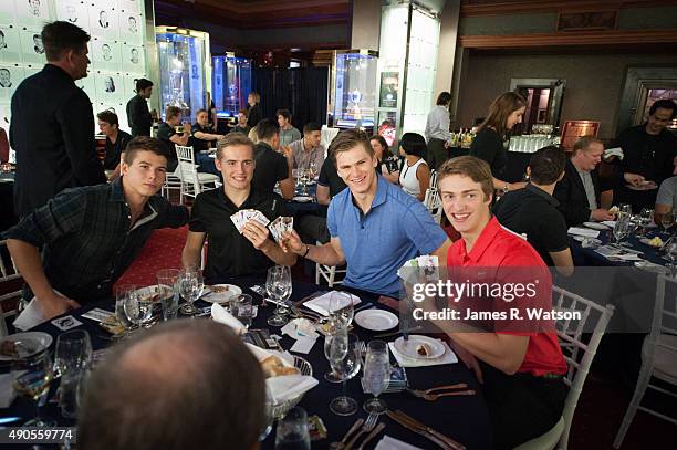 Prospects Nikolay Goldobin, Ivan Barbashev, Samuel Morin, and Travis Sanheim open packs of Upper Deck hockey cards during dinner at the Hockey Hall...