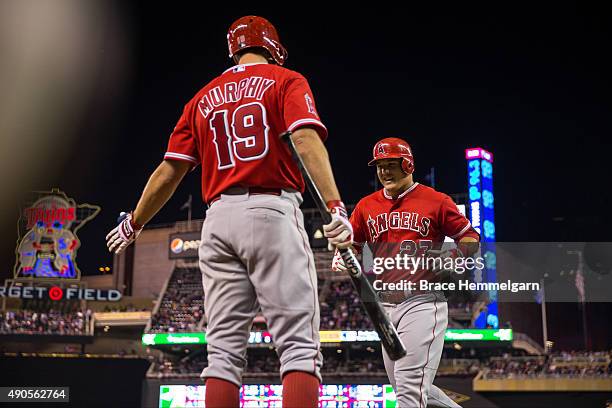 Mike Trout of the Los Angeles Angels celebrates his home run with David Murphy in the second game of a doubleheader against the Minnesota Twins on...