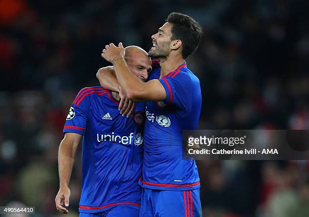 Alberto Botia and Esteban Cambiasso of Olympiacos celebrate the win after the UEFA Champions League match between Arsenal and Olympiacos at the...