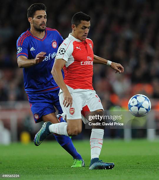 Alexis Sanchez of Arsenal takes on Alberto Botia of Olympiacos during the match between Arsenal and Olympiacos on September 29, 2015 in London,...