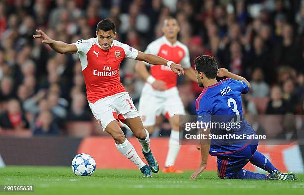 Alexis Sanchez of Arsenal takes on Alberto Botia of Olympiacos during the UEFA Champions League match between Arsenal and Olympiacos at Emirates...