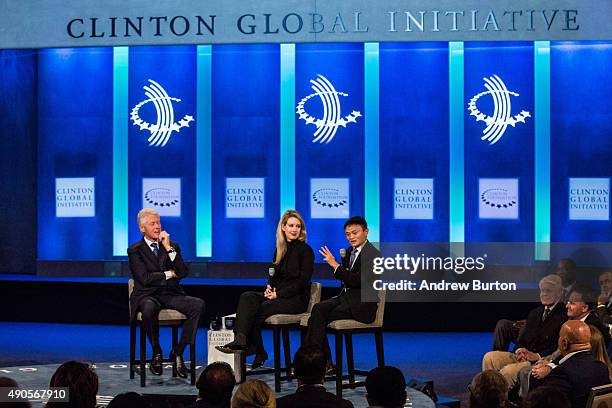 Former U.S. President Bill Clinton; Elizabeth Holmes, founder and CEO of Theranos; and Jack Ma, executive chairman of Alibaba Group, speak at the...