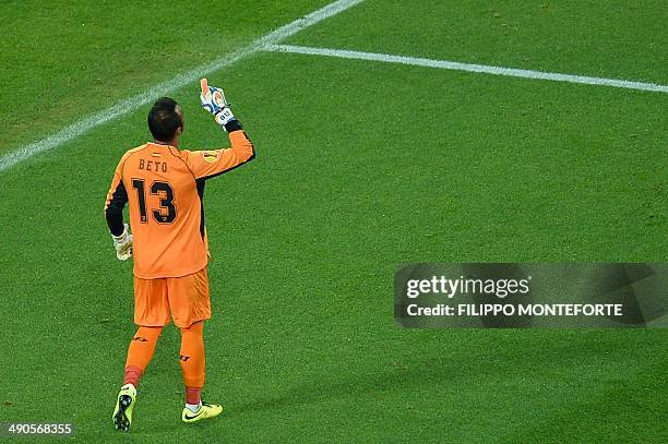 Sevilla's Portuguese goalkeeper Beto celebrates after making a save on a penalty during the UEFA Europa league final football match between Benfica...